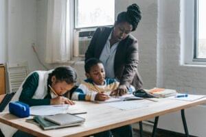 Parent assisting child with KEPSEA and KJSEA online revision for Grade 6 and 9 exams